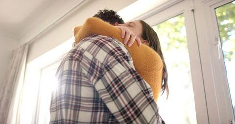 Loving Couple Embracing in Sunlit Home