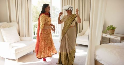 Indian Women Embracing VR Technology in Traditional Dress