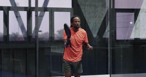 Mature African American Athlete Holding Padel Racket on Indoor Court