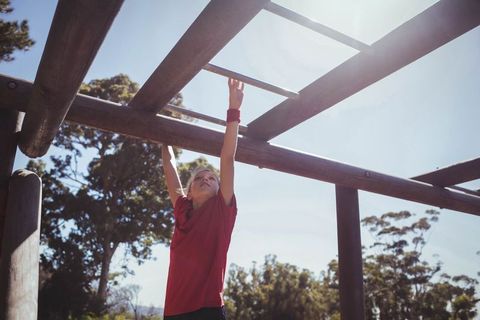 Child Reaching on Playground Monkey Bars