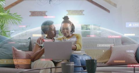 Senior and adult women browsing laptop together on cozy couch with social media overlays