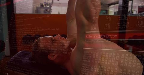 Athlete bench pressing with digital code overlay displaying strength and technology
