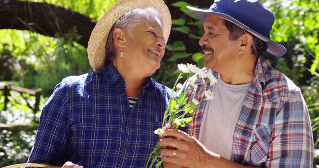 Senior Latino Couple Enjoying Outdoor Nature With Flowers - Download Free Stock Images Pikwizard.com