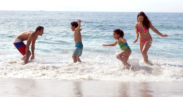 Family enjoying time at the beach, splashing in waves. Perfect for travel agencies, vacation advertisements, family activities, and lifestyle promotions.
