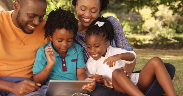 Happy Family Enjoying Time Together Using Tablet Outdoors - Download Free Stock Images Pikwizard.com