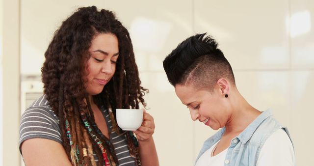 Two friends enjoying coffee and conversation in natural light - Download Free Stock Images Pikwizard.com