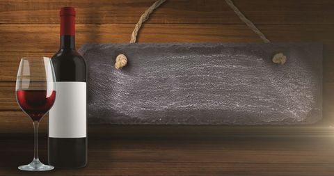 elegant wine bottle and glass beside blank slate - Download Free Stock Images Pikwizard.com