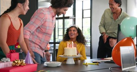 Colleagues celebrating birthday at office gathering joyful occasion