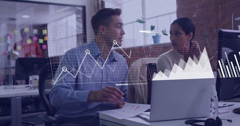 Colleagues Analyzing financial Trends with Digital Graphs in Office