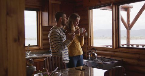 Couple Enjoying Tea Inside a Lakeside Log Cabin - Download Free Stock Images Pikwizard.com