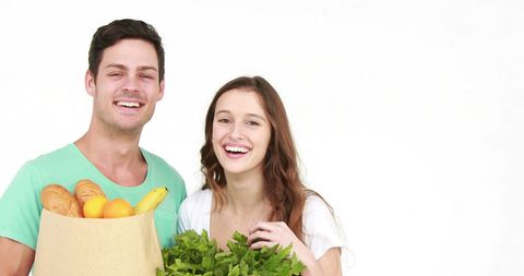 Smiling Couple Holding Grocery Bag with Fresh Produce - Download Free Stock Images Pikwizard.com