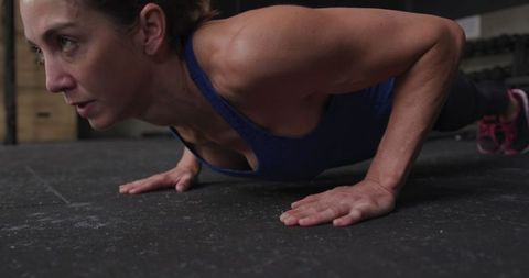 Athletic Woman Performing Push-Ups in Gym Close-Up