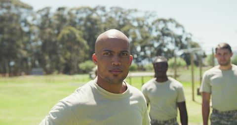 Military Trainer Leading Diversified Group in Obstacle Course Training