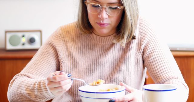 Young Woman Enjoying Breakfast Cereal at Home - Download Free Stock Images Pikwizard.com