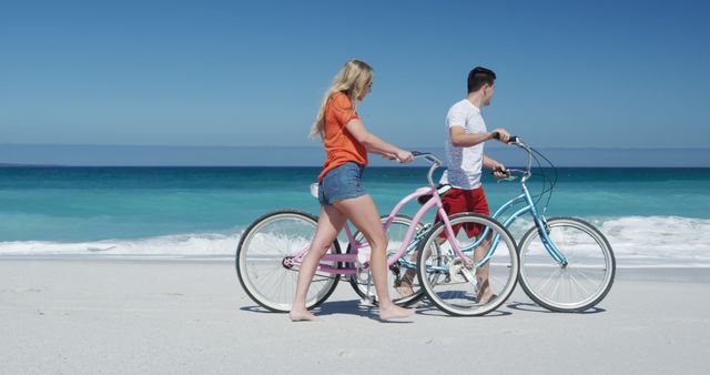 Couple Walking Bicycles Along Beach Shoreline - Download Free Stock Images Pikwizard.com