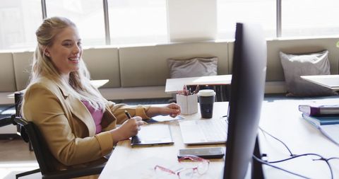 Businesswoman in Wheelchair Working in Bright Office Space - Download Free Stock Images Pikwizard.com