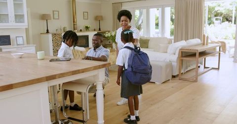 Family Morning Routine: Parents Assisting Children with School Preparations