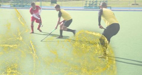 Controlling midfielder shielding ball on turf during field hockey match, dynamic motion