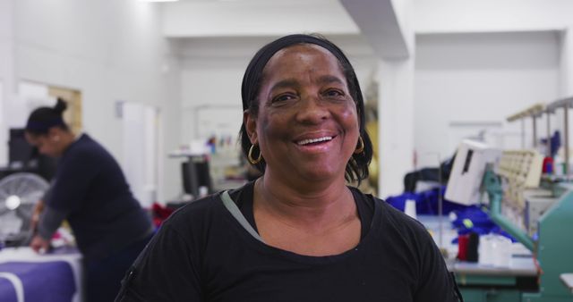 Smiling Female Factory Worker in Black Shirt and Black Headband - Download Free Stock Images Pikwizard.com