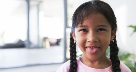 Joyful Biracial Girl Showing Playful Expression Indoors