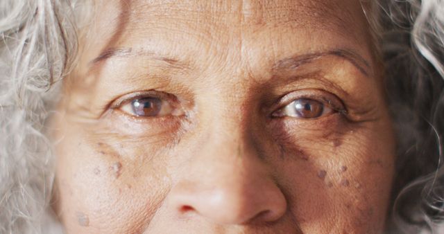 Depicting the wisdom and natural beauty of aging, perfect for campaigns centered on senior health, aging gracefully, or personal stories of elderly individuals. This close-up highlights individuals' experiences and conveys emotion through lines and features.