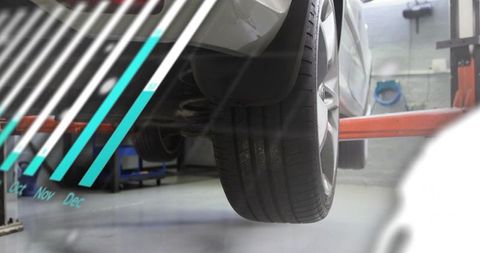 Car wheel and tire close-up on lift showing seasonal maintenance graph overlay