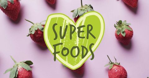 Super Foods Text Overlying Fresh Strawberries on Pink Background