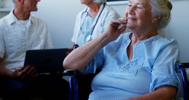 Happy Elderly Woman in Wheelchair with Medical Professionals - Download Free Stock Images Pikwizard.com