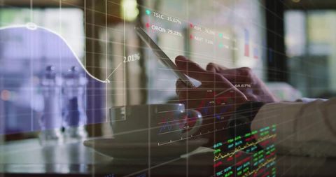 Businessman Analyzing Financial Data on Tablet in Café Setting