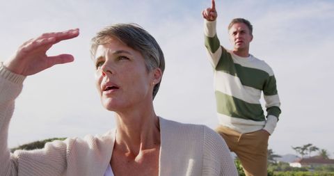 Caucasian Senior Couple Gazing at Distant Horizon on Sunny Coastline - Download Free Stock Images Pikwizard.com