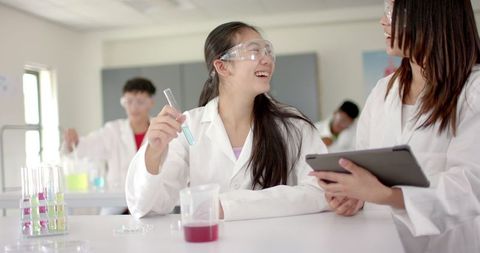 Teenage Asian Student Conducting Science Experiment with Teacher - Download Free Stock Images Pikwizard.com