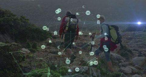 Mature adults hiking with digital connection interface in nature