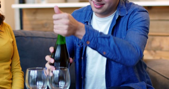 Happy Man Opening Wine Bottle with Friends at Home - Download Free Stock Images Pikwizard.com