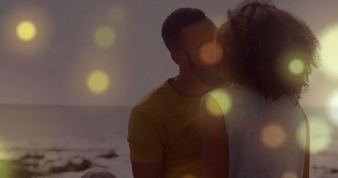 Couple Kissing at Beach with Dazzling Light Flares