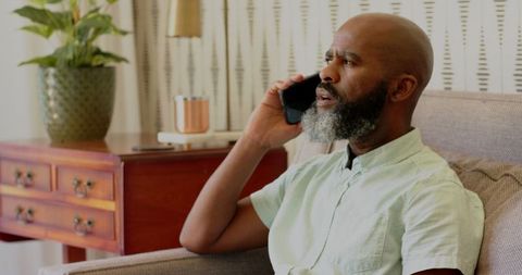 Man Talking on Phone at Home in Bright Living Space
