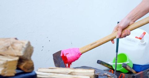 Lumberjack chopping wood with brightly wrapped axe