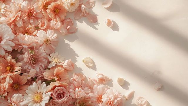 Peach blush chrysanthemum and rose flatlay bathing in soft sunlight with scattered petals
