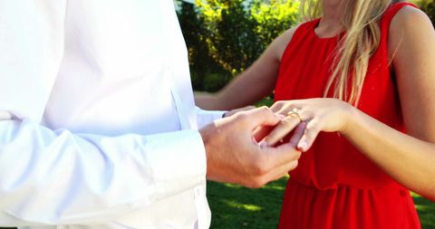 Romantic Proposal as Man Puts Ring on Woman's Finger