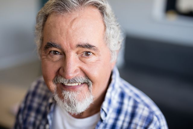 Portrait of smiling senior man with beard at nursing home