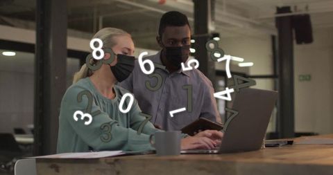 Colleagues Wearing Masks Analyzing Data in Modern Office Environment