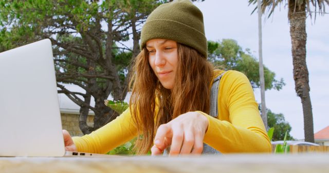 Young Woman Using Laptop Outdoors in Casual Attire - Download Free Stock Images Pikwizard.com