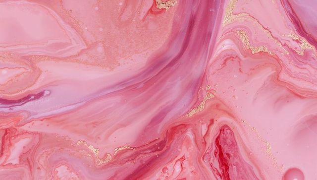 Luxurious pink and red swirling marble texture with gold veins