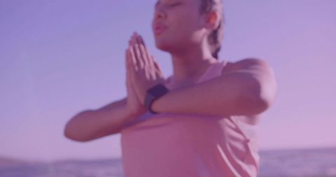 Woman Practicing Yoga Prayer Pose On Beach During Sunset
