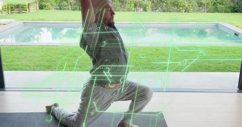 Bearded man practicing low lunge yoga with augmented reality fitness overlay poolside