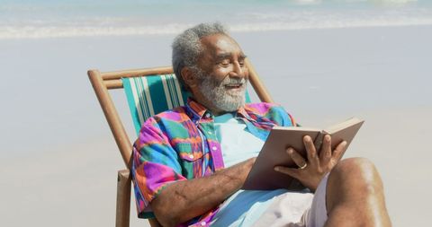 Senior Man Relaxing at Beach Reading Book and Enjoying Sunny Day - Download Free Stock Images Pikwizard.com