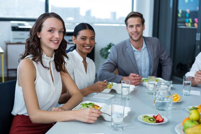 Portrait of smiling business executives having meal in office