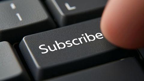 Finger Pressing Subscribe Key on Keyboard Macro Closeup for Digital Subscription Concept