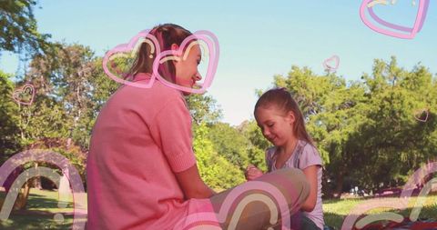 Mother and Daughter Bonding Outdoors with Heart Overlays