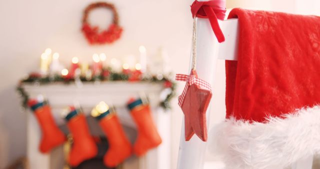 Festive Christmas Decorations on Chair with Fireplace in Background - Download Free Stock Images Pikwizard.com