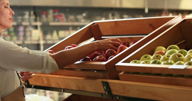 Woman picking out fruit in supermarket in high quality 4k format